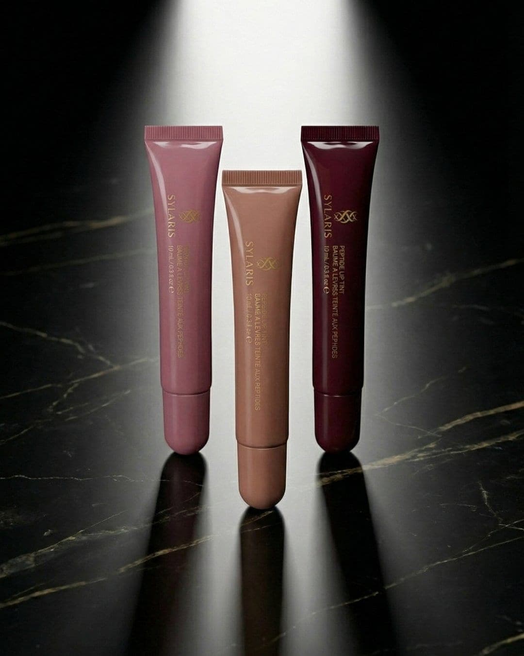 Three Sylaris lip tints on black marble under a spotlight, AI-generated ad still