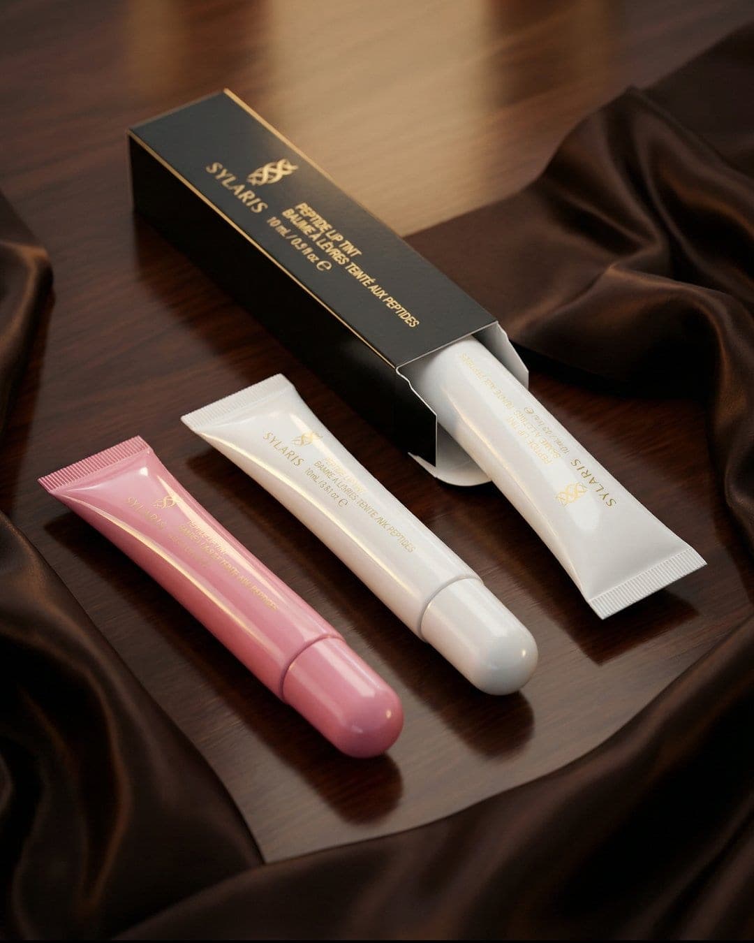 Sylaris lip tints and packaging on brown satin, AI-generated product still