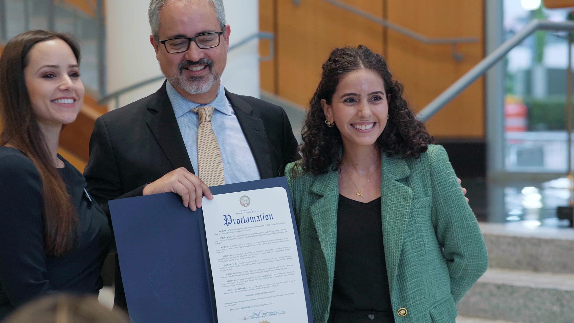 Guests pose with the Brazilian Independence Day proclamation at Orlando City Hall